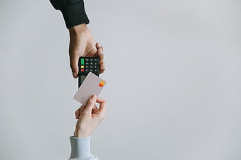 Modern contactless payment using a card and terminal, highlighting the ease of digital transactions. HD wallpaper