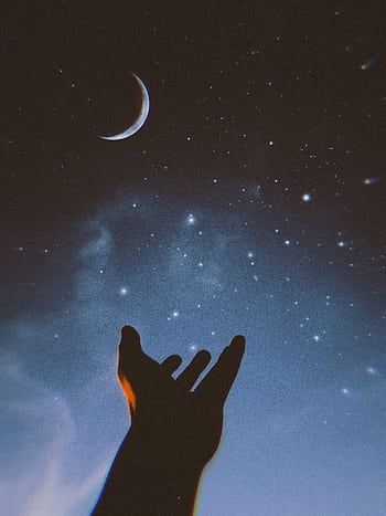 Silhouetted hand reaching out to a crescent moon amid a starry sky, creating a dreamy and celestial scene. HD phone wallpaper