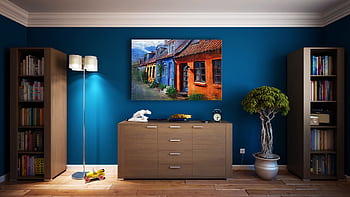 A modern living room featuring stylish bookshelves, a vibrant painting, and minimalistic decor. HD wallpaper
