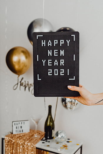 A vibrant New Year celebration featuring balloons and festive decorations with a 'Happy New Year 2021' sign. HD phone wallpaper