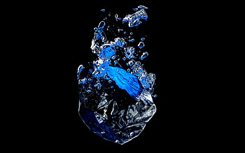 Ice cube falling into water against a black background with bubbles HD wallpaper