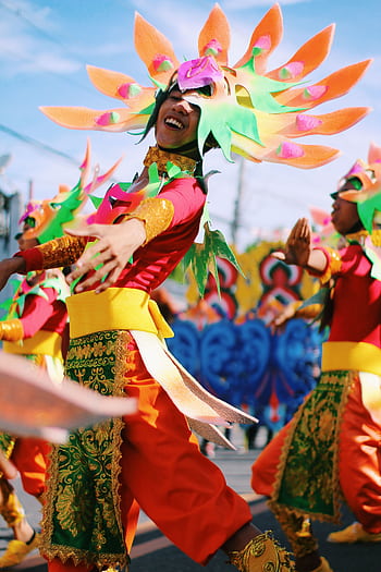 Colorful dancers in traditional attire celebrate the Gubat Festival outdoors. HD phone wallpaper