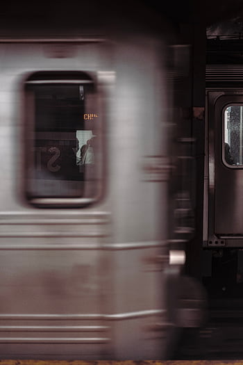 Dynamic shot of a subway train in motion, capturing the energy of public transportation. HD phone wallpaper