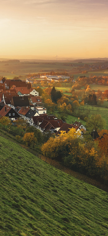 Peaceful mountain town, Fall colors, Tranquil atmosphere, Serene tree backdrop HD phone wallpaper