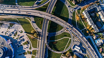 Aerial graph of a complex highway interchange, capturing dynamic city traffic. HD wallpaper