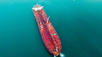 Aerial shot of an oil tanker cruising through the ocean, emphasizing maritime transport. HD wallpaper