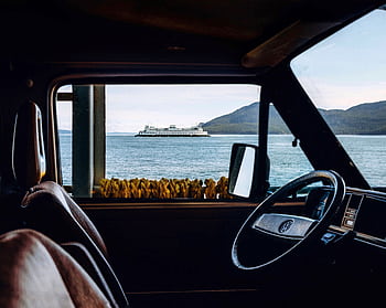 Enjoy a view of a ferry from inside a vehicle, blending travel and nature. HD wallpaper