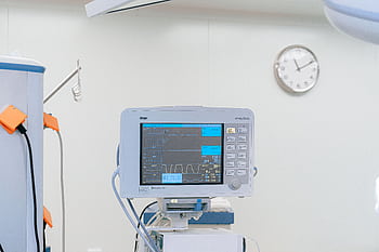 A modern heart rate monitor in a sterile hospital setting, showcasing medical technology. HD wallpaper