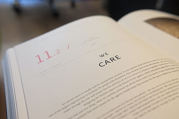 Close-up of an open book highlighting the theme of care and compassion, ideal for educational and business contexts. HD wallpaper