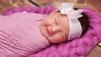 Smiley Cute Baby With Closed Eyes Is Covering With Pink Netted Towel Having White Ribbon Band On Head Cute HD wallpaper
