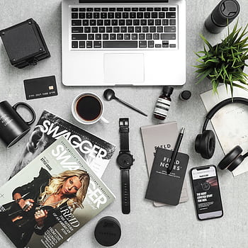 Flat lay of a stylish workspace with laptop, , coffee, and tech accessories. HD phone wallpaper