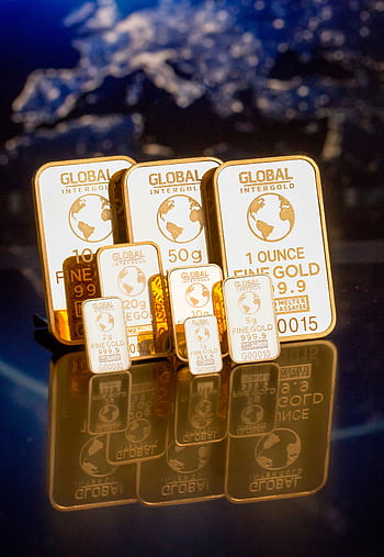 Collection of gold bars featuring a global map and weight inscriptions. HD phone wallpaper