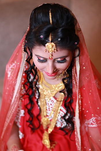 A beautiful Indian bride in traditional attire and jewelry, captured in a close-up portrait. HD phone wallpaper