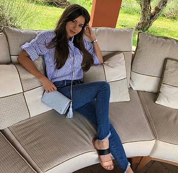 Shelby Chesnes, sofa and cushions, brunette, pocket book with long chain, blue striped blouse, jeans, slip on flat sandals, sitting, watch, rolled cuffs, outdoor living area HD wallpaper