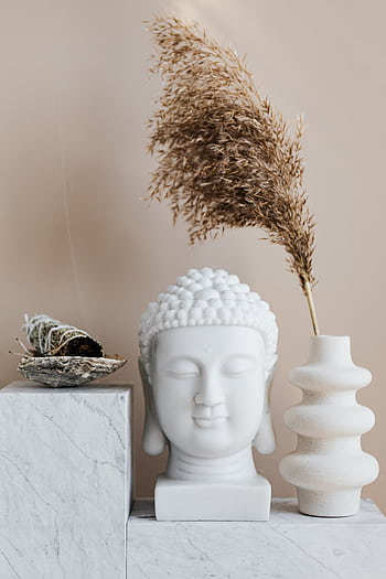 Tranquil interior scene showcasing a Buddha bust with a vase and sage on a shelf. HD phone wallpaper