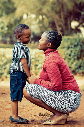 A heartfelt moment between a mother and son outdoors in Kenya, capturing love and connection. HD phone wallpaper