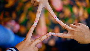 Close-up of hands forming a star shape, symbolizing unity and friendship. HD wallpaper