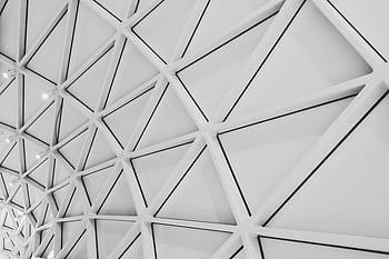 An intricate ceiling design featuring modern geometric patterns and steel structures in a low angle shot. HD wallpaper