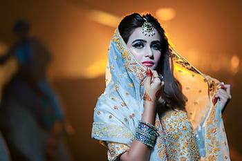 Beautiful Indian bride in traditional attire with intricate jewelry and makeup. HD wallpaper
