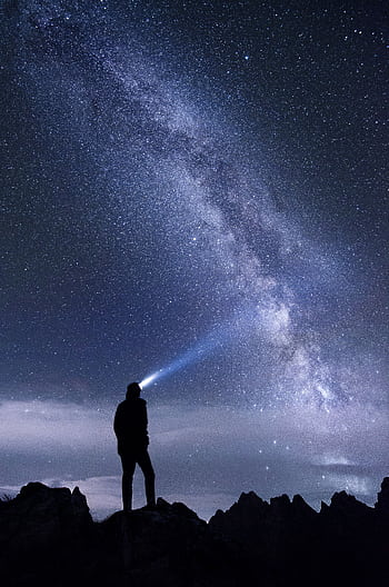 Silhouette of a person exploring the star-studded Milky Way sky at night in the mountains. HD phone wallpaper