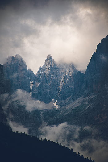 Scenic view of dramatic mountain peaks shrouded in clouds. HD phone wallpaper