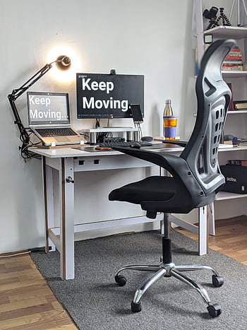 Stylish home office with ergonomic chair, desk, laptop, and motivational screens. HD phone wallpaper