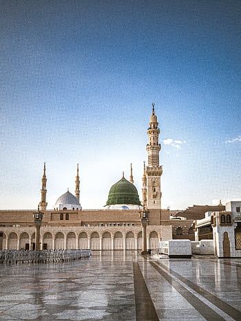 The Prophet's Mosque in Madinah with its iconic green dome, a significant Islamic landmark. HD phone wallpaper