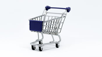 A modern miniature shopping cart on a clean white background, perfect for e-commerce concepts. HD wallpaper
