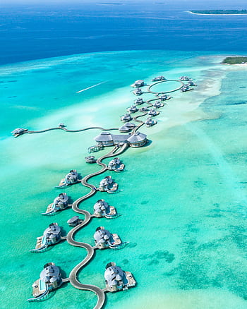 Aerial view of luxury overwater villas at Noonu Atoll, Maldives with turquoise waters. HD phone wallpaper