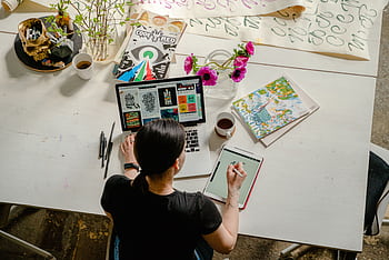 Artistic workspace featuring calligraphy and digital design on a tablet and laptop. HD wallpaper