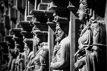 Black and white of historic stone sculptures showcasing intricate craftsmanship. HD wallpaper
