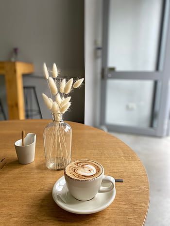 A comforting coffee experience in a minimalist café setting, perfect for a relaxed morning or coffee break. HD phone wallpaper