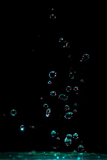 Captivating of water bubbles suspended in motion against a dark background. HD phone wallpaper