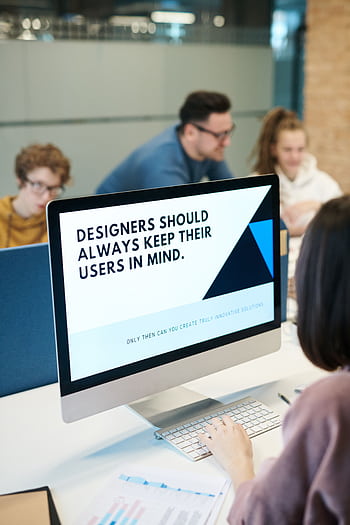Group of designers collaborating in modern office space with computer. HD phone wallpaper