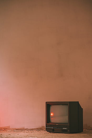 An old CRT TV in a minimalist room with warm lighting and vintage style. HD phone wallpaper