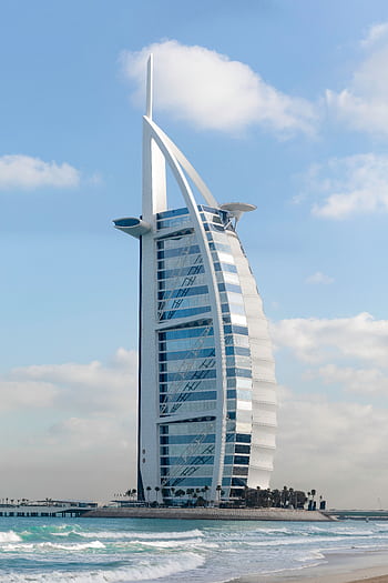 Stunning view of the iconic Burj Al Arab hotel against a clear blue sky in Dubai, UAE. HD phone wallpaper