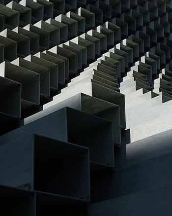 A modern abstract architectural design featuring geometric cubes and lines, captured in dramatic light. HD phone wallpaper