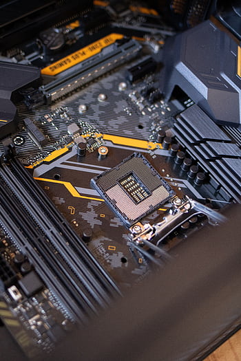 Detailed view of a computer motherboard highlighting electronic components and technology connections. HD phone wallpaper