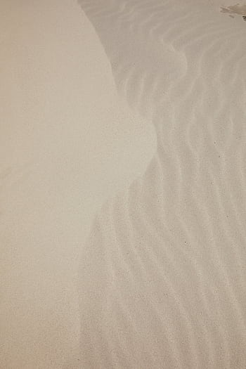 A minimalistic aerial shot of rippled sand patterns on a quiet sandy beach, perfect for backgrounds. HD phone wallpaper