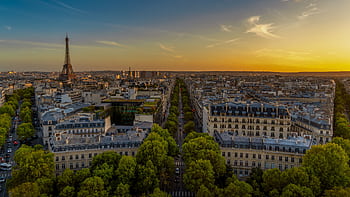 Scenic aerial view of Paris featuring the Eiffel Tower at sunset, capturing the tranquil cityscape. HD wallpaper