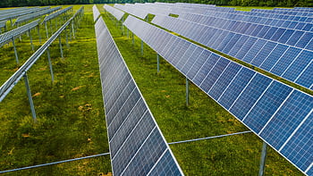 Aerial view of solar panels in a green field, Rossville, GA. HD wallpaper