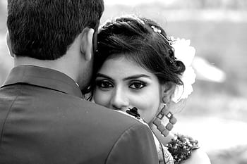 Close-up black and white portrait of a bride embracing her groom outdoors. HD wallpaper
