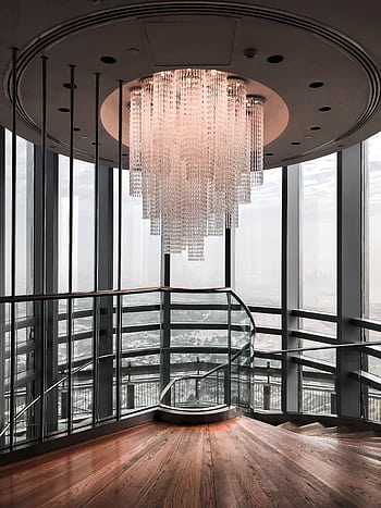 Elegant modern staircase interior featuring a large crystal chandelier and glass walls. HD phone wallpaper
