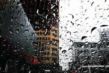 Dramatic cityscape seen through rain-covered window in Shanghai, China. HD wallpaper