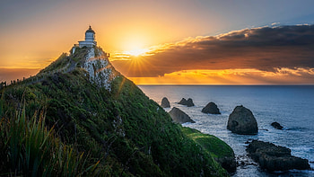 Nugget Point Lighthouse, New Zealand, sunset, coast, sea, colors, sky, rocks, sun HD wallpaper