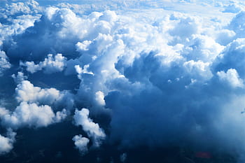 A stunning aerial view of fluffy white clouds over France, showcasing a serene and peaceful cloudscape. HD wallpaper