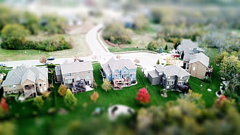 Aerial showcasing residential houses in a suburban neighborhood with lush greenery and streets. HD wallpaper