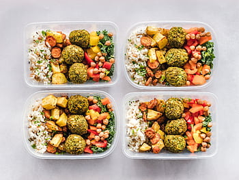 Colorful meal prep containers with falafel, chickpeas, rice, and vegetables for a healthy lifestyle. HD wallpaper