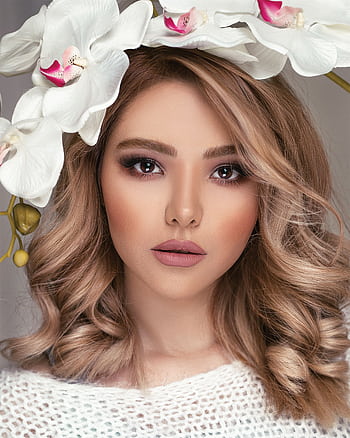 A stunning portrait of a woman adorned with a floral headpiece, highlighting beauty and elegance. HD phone wallpaper