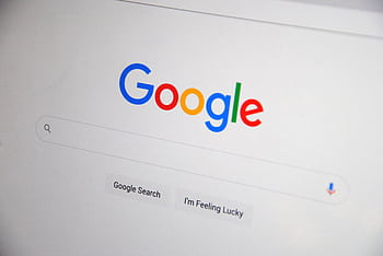Close-up of the Google homepage on a screen showing search options. HD wallpaper